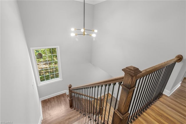 411 Motif Ln, Winston-Salem, NC 27107 - staircase featuring a chandelier, wood finished floors, and lofted ceiling