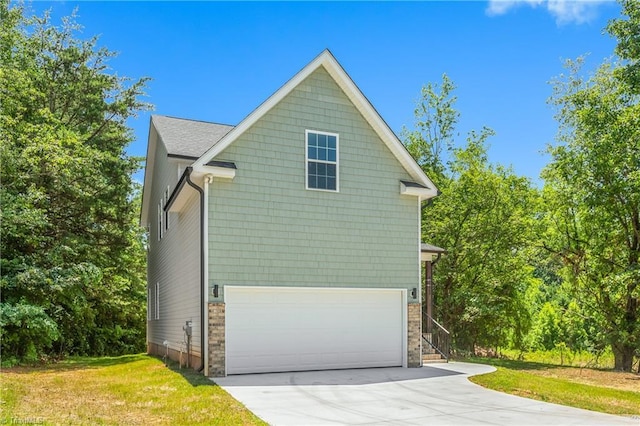 411 Motif Ln, Winston-Salem, NC 27107 - view of side of property featuring concrete driveway, an attached garage, a yard, and stone siding