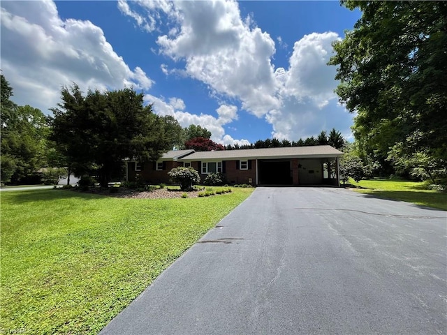 4211 Village Dr, Trinity, NC 27370 - single story home featuring driveway, a front lawn, an attached carport, and a garage