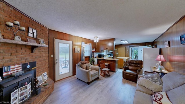 4211 Village Dr, Trinity, NC 27370 - living area featuring light wood finished floors, a textured ceiling, and wooden walls