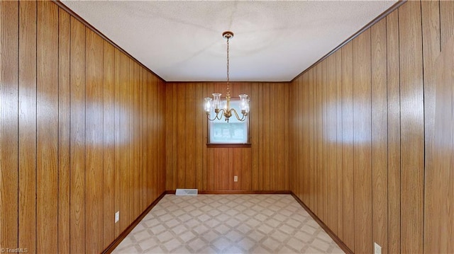 4211 Village Dr, Trinity, NC 27370 - empty room featuring light floors, a chandelier, and wooden walls