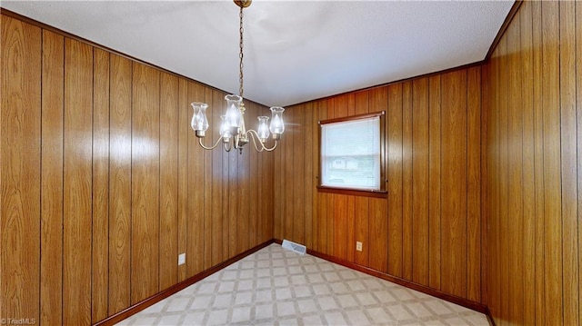 4211 Village Dr, Trinity, NC 27370 - spare room with a chandelier, light floors, and wood walls