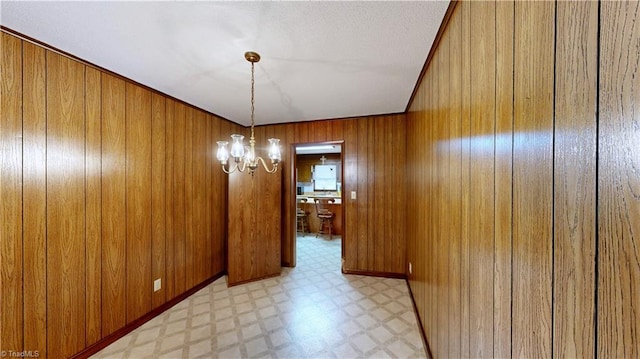 4211 Village Dr, Trinity, NC 27370 - unfurnished dining area with light flooring, wooden walls, and a chandelier