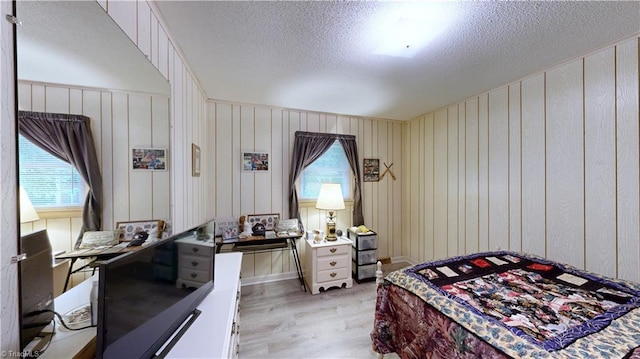 4211 Village Dr, Trinity, NC 27370 - bedroom with light wood-type flooring, multiple windows, and a textured ceiling