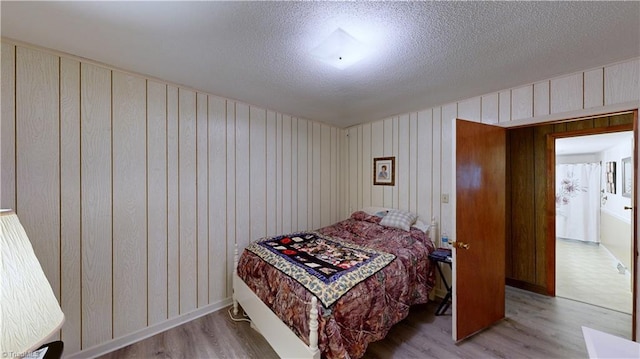 4211 Village Dr, Trinity, NC 27370 - bedroom with wood finished floors, a textured ceiling, and wooden walls