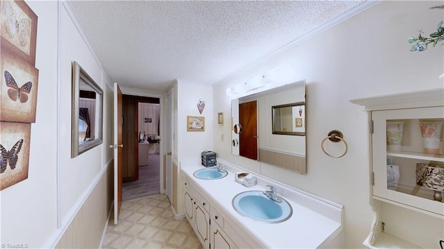 4211 Village Dr, Trinity, NC 27370 - bathroom with a textured ceiling, double vanity, crown molding, and tile patterned floors