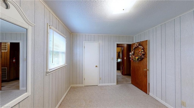4211 Village Dr, Trinity, NC 27370 - unfurnished room featuring a textured ceiling, baseboards, wood walls, and carpet