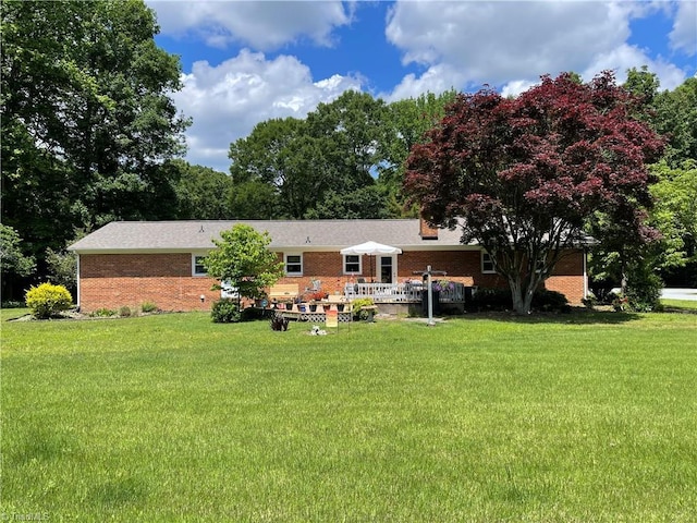 4211 Village Dr, Trinity, NC 27370 - back of house with brick siding, a lawn, and a wooden deck