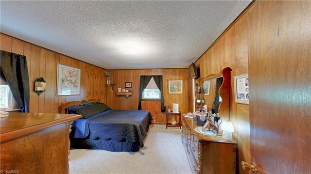 4211 Village Dr, Trinity, NC 27370 - bedroom featuring light carpet, wood walls, and a textured ceiling