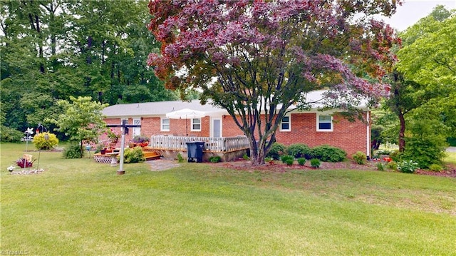 4211 Village Dr, Trinity, NC 27370 - back of property featuring a yard, brick siding, and a wooden deck
