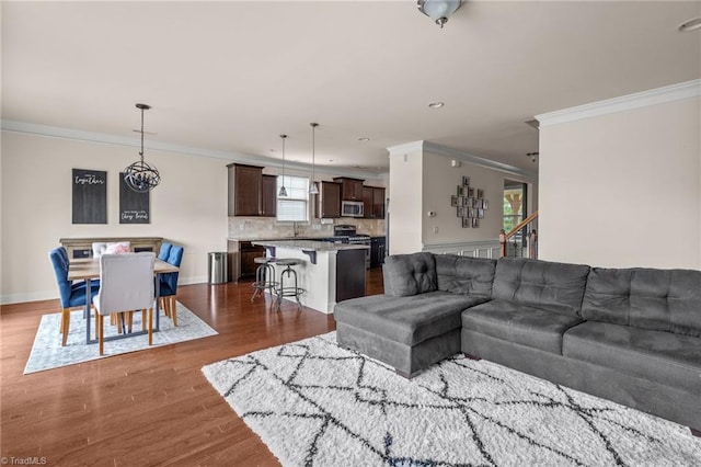 living room featuring dark hardwood / wood-style flooring and ornamental molding