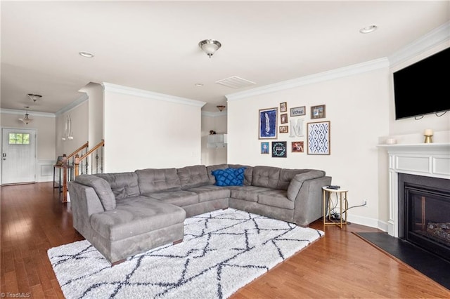 living room with dark hardwood / wood-style flooring and ornamental molding