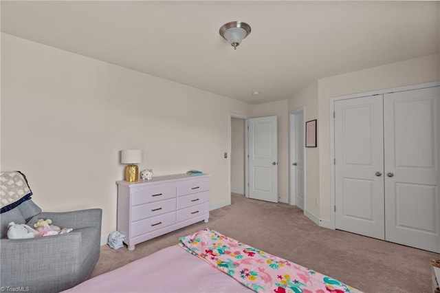 bedroom with light colored carpet and a closet