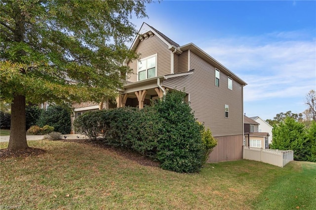 view of side of home featuring a lawn