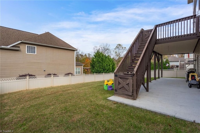 view of yard featuring a wooden deck and a patio