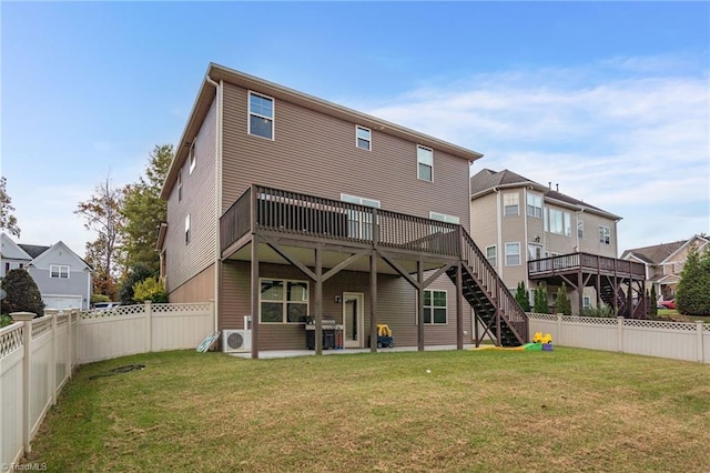 rear view of house with a yard and a deck