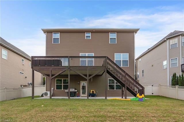 back of house featuring a lawn, a patio area, and a wooden deck