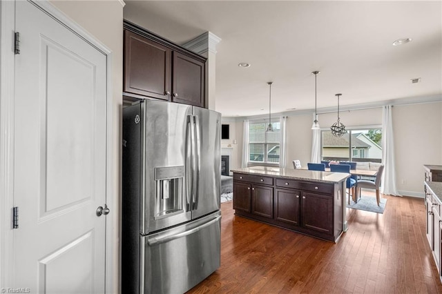 kitchen featuring pendant lighting, dark brown cabinets, stainless steel fridge, and dark wood-type flooring