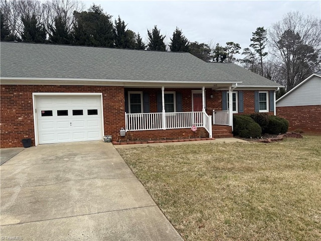 ranch-style house featuring a garage, covered porch, and a front lawn