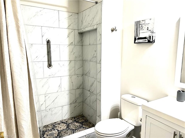 full bathroom with vanity, toilet, and a shower stall