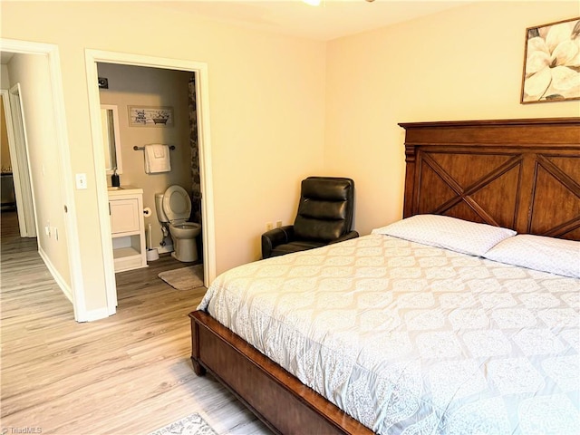 bedroom with light wood-type flooring and baseboards