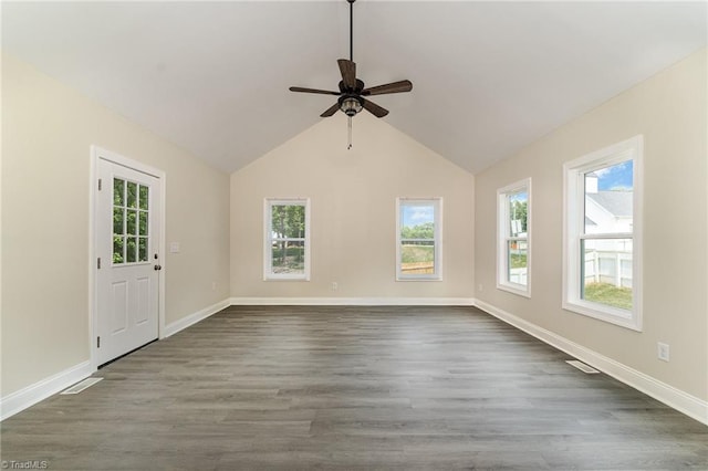 unfurnished room featuring ceiling fan, plenty of natural light, dark hardwood / wood-style flooring, and lofted ceiling