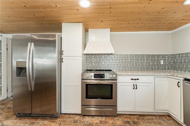 kitchen with premium range hood, decorative backsplash, stainless steel appliances, white cabinets, and wooden ceiling