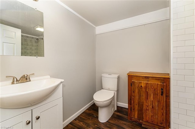 bathroom with hardwood / wood-style floors, vanity, a shower, toilet, and crown molding