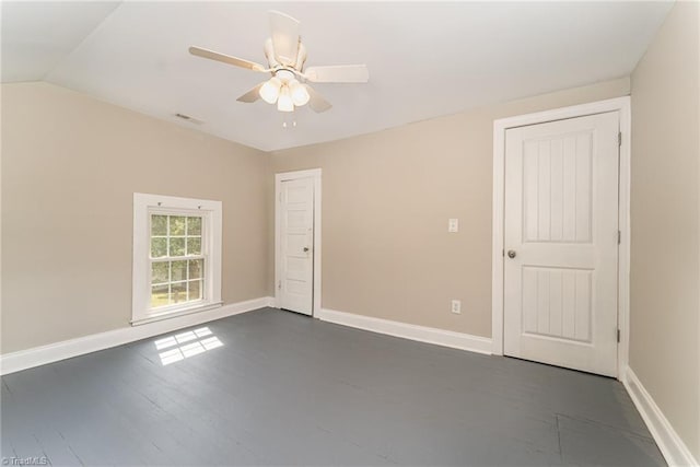 spare room featuring vaulted ceiling and ceiling fan