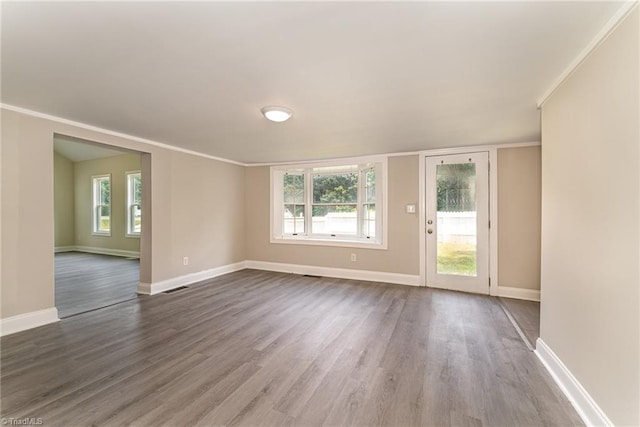 empty room featuring hardwood / wood-style flooring and ornamental molding