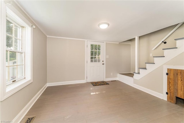 entryway with hardwood / wood-style floors and a healthy amount of sunlight