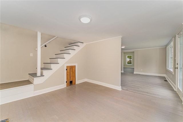 interior space featuring light hardwood / wood-style floors and ornamental molding