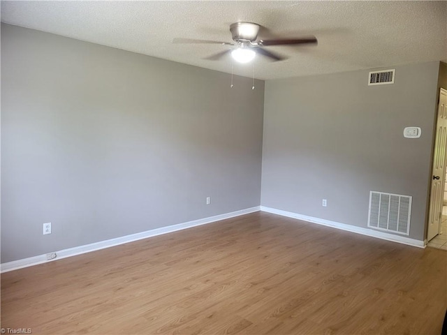 4001 S Bend Dr Unit 101, Winston-Salem, NC 27107 - empty room featuring a ceiling fan, light wood-style floors, baseboards, and a textured ceiling