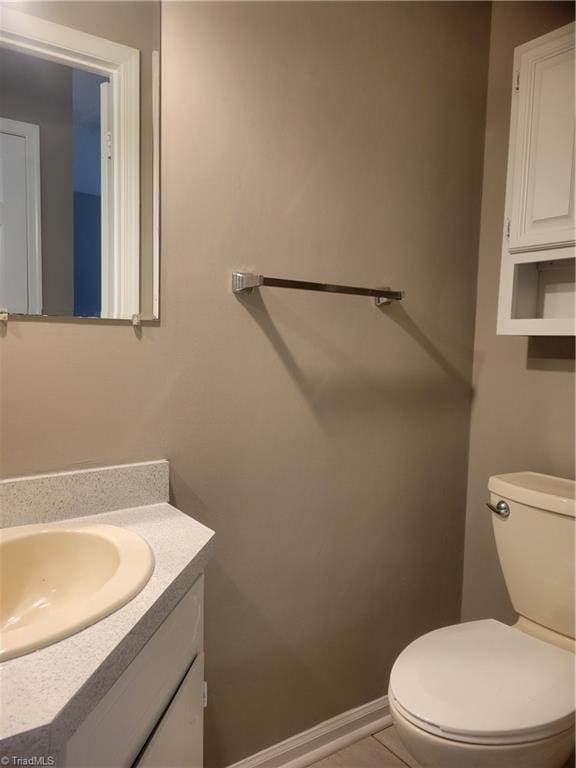 4001 S Bend Dr Unit 101, Winston-Salem, NC 27107 - half bathroom featuring vanity, toilet, baseboards, and tile patterned floors