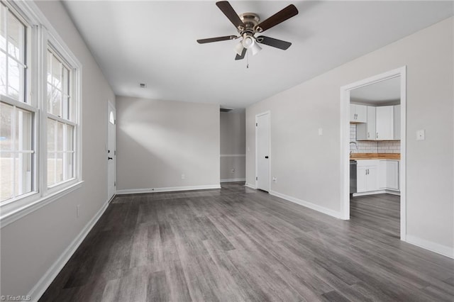 unfurnished room featuring sink, hardwood / wood-style flooring, and ceiling fan