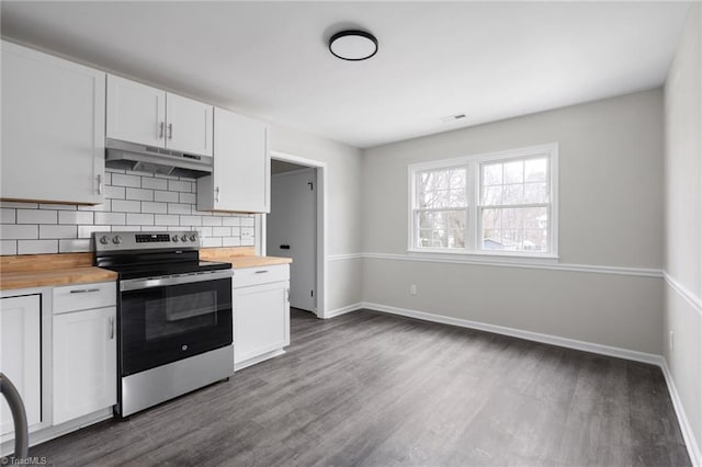 kitchen with tasteful backsplash, wooden counters, stainless steel electric range oven, dark hardwood / wood-style floors, and white cabinets