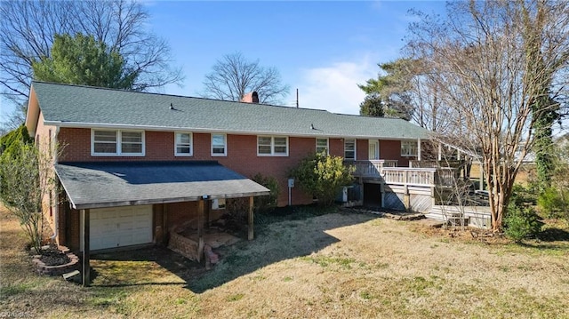 rear view of house with brick siding, a chimney, an attached garage, a deck, and driveway