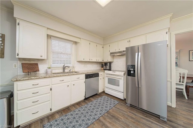 kitchen featuring tasteful backsplash, white cabinets, sink, and stainless steel appliances