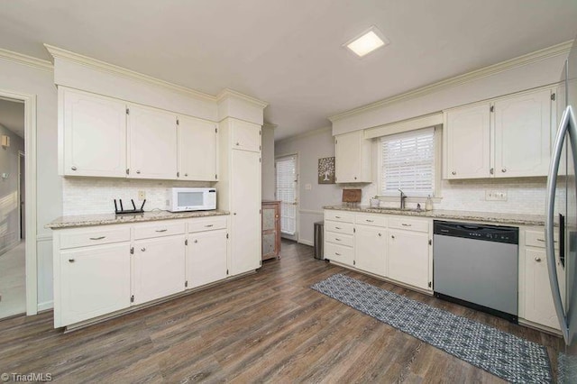 kitchen with stainless steel dishwasher, decorative backsplash, sink, white cabinets, and dark hardwood / wood-style flooring