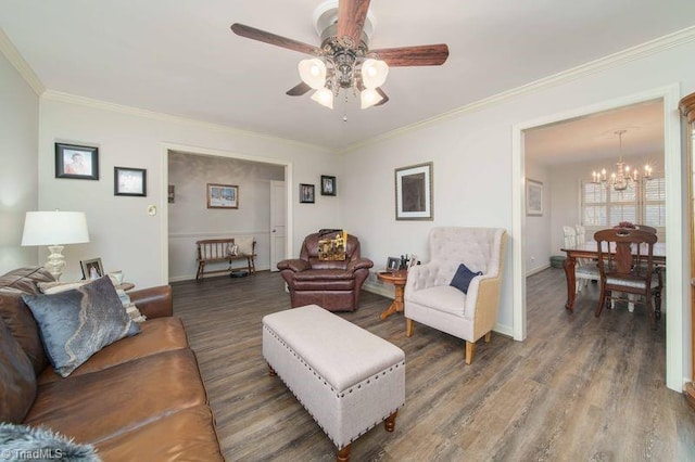 living room featuring ceiling fan with notable chandelier, dark hardwood / wood-style flooring, and ornamental molding