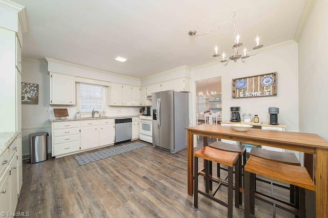 kitchen featuring an inviting chandelier, white cabinetry, stainless steel appliances, dark hardwood / wood-style floors, and light stone counters