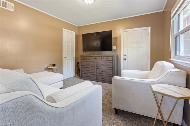 living area with ornamental molding, carpet flooring, and visible vents