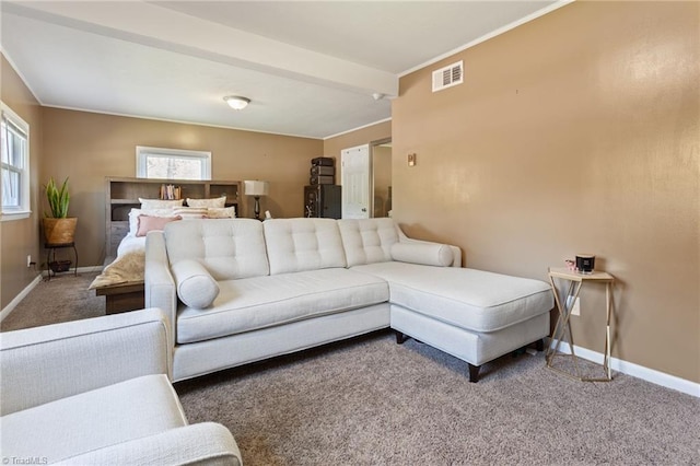 living room with baseboards, visible vents, and carpet