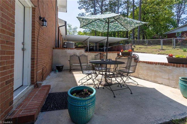 view of patio featuring fence and outdoor dining space