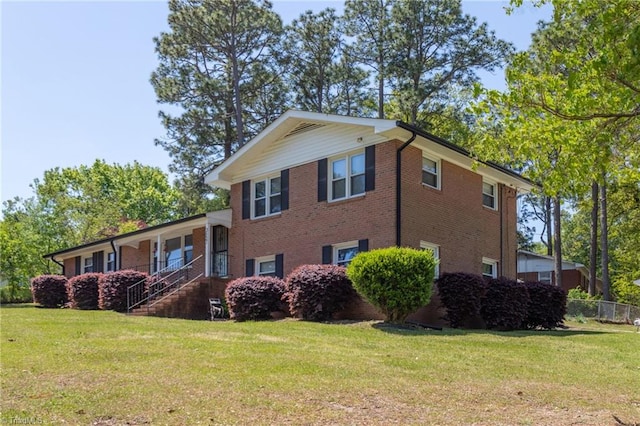 view of property exterior with brick siding and a yard