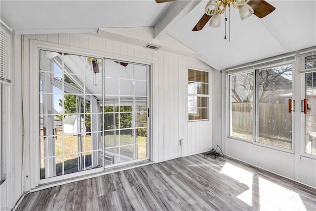 unfurnished sunroom featuring visible vents, ceiling fan, and vaulted ceiling with beams