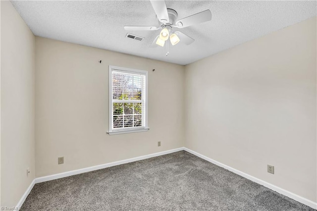 unfurnished room featuring a ceiling fan, carpet, visible vents, and a textured ceiling