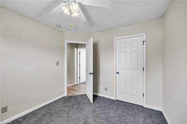 unfurnished bedroom with baseboards, carpet, a ceiling fan, and a textured ceiling