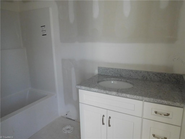 full bathroom with walk in shower, a washtub, and vanity