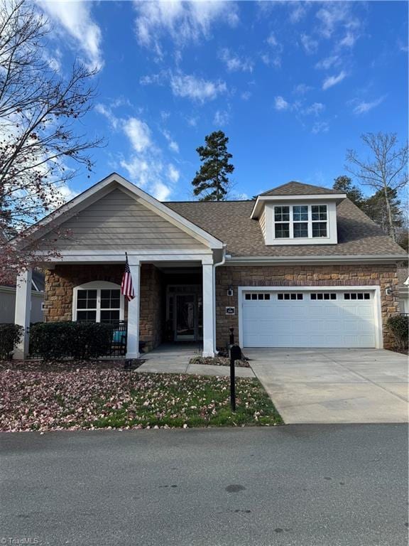 view of front of house featuring covered porch and a garage